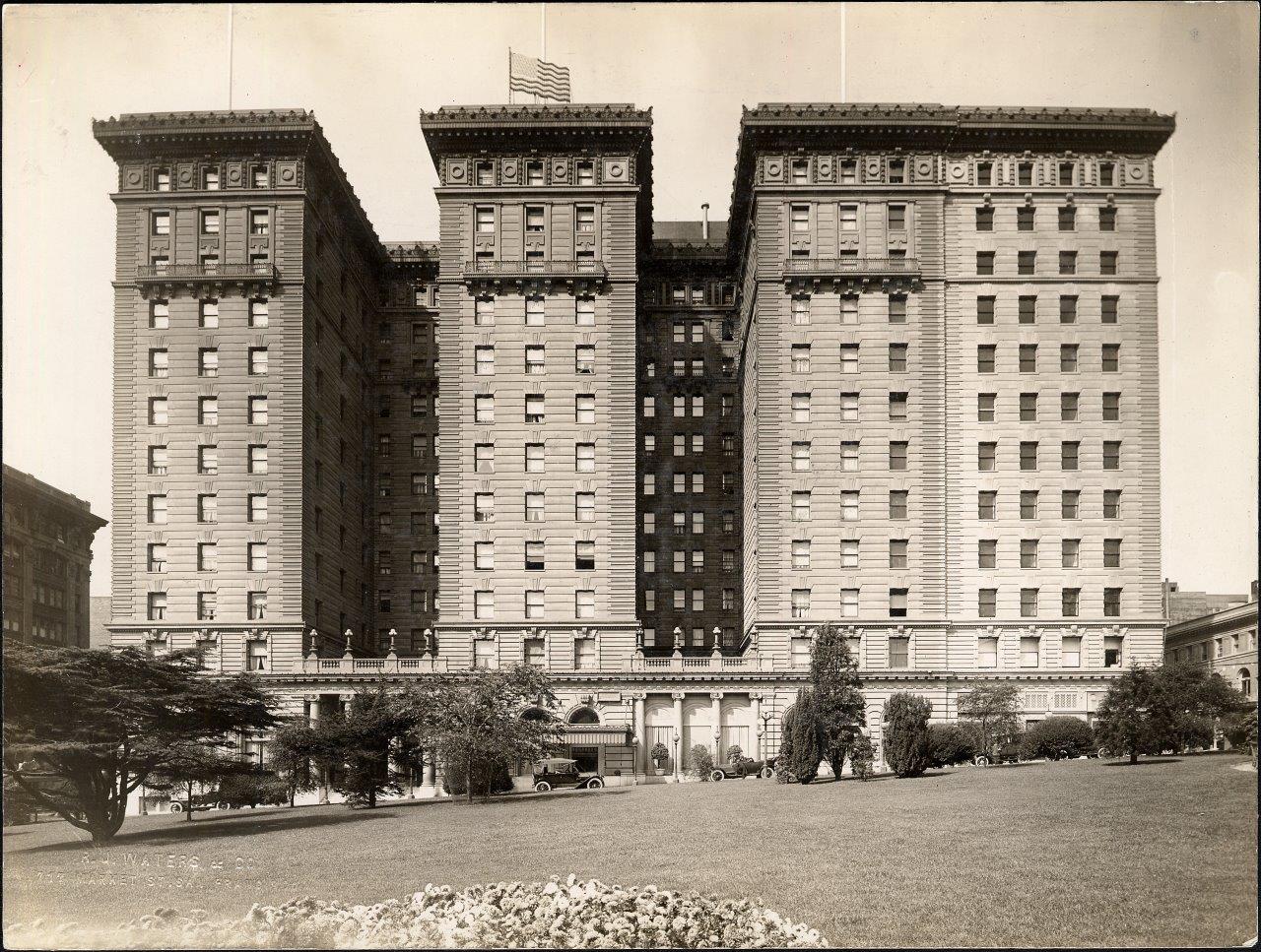 A photograph shows a multistory hotel building.