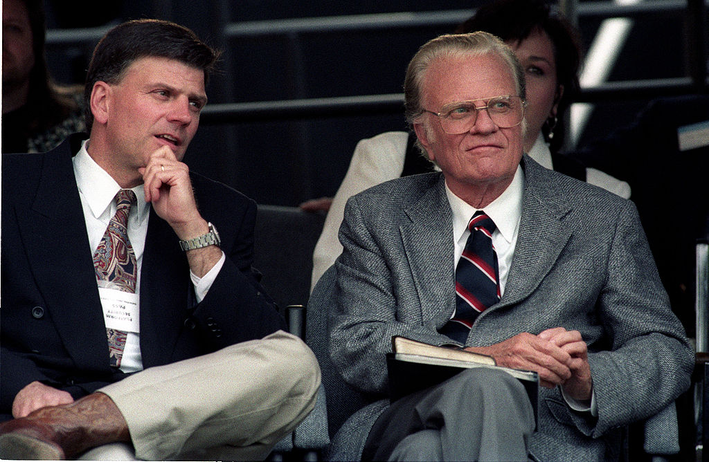 A photograph shows Franklin and Billy Graham sitting together in stadium seats.