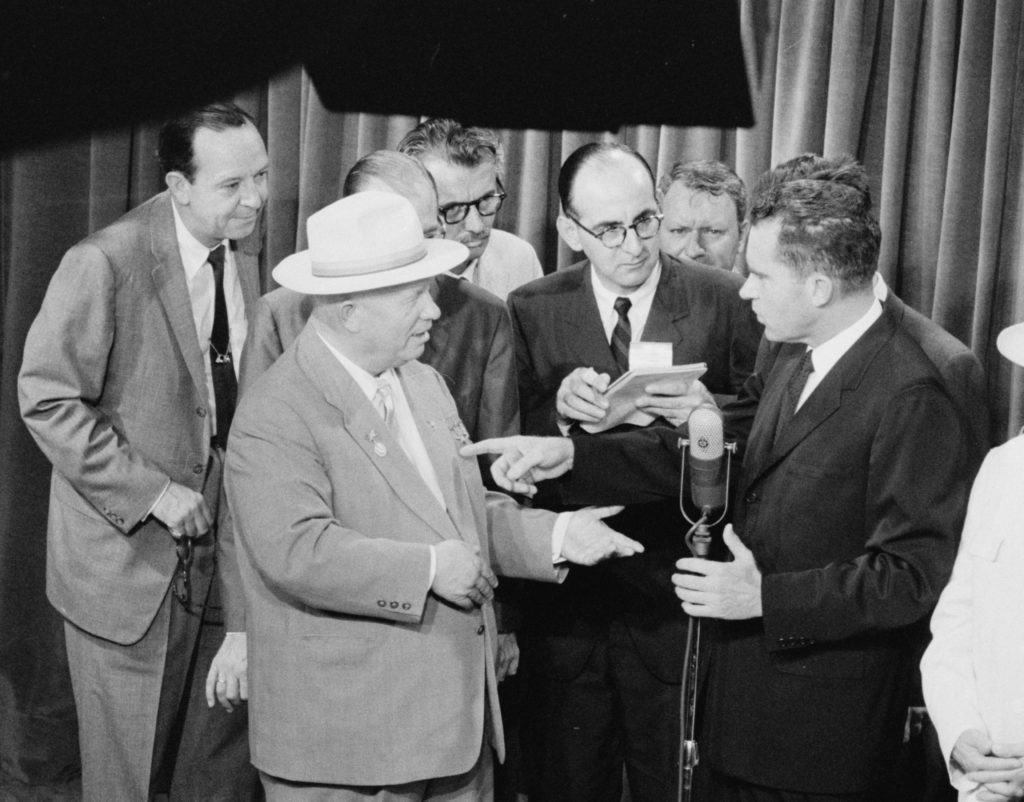 A photograph shows Nixon and Khrushchev standing on opposite sides of a microphone. They appear to be in heated debate.