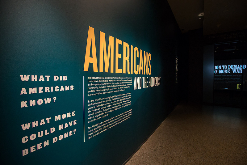 A large panel includes paragraphs of text under the large words "Americans and the Holocaust."