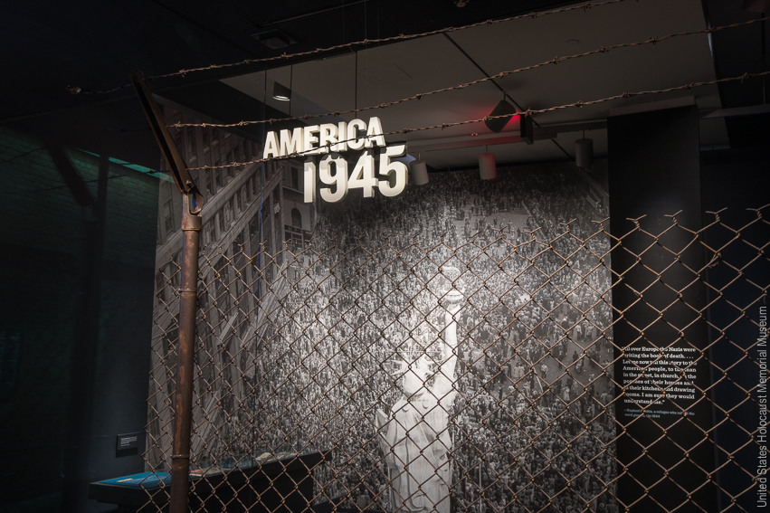 A large barbed wire fence appears with display text that reads "America 1945."