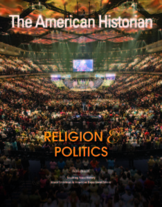 This magazine cover displays the image of an auditorium filled with worshipers and several big screens. Text over the image reads Religion and Politics. Also inside: Teaching Trans History. Black Christmas in American Department Stores.
