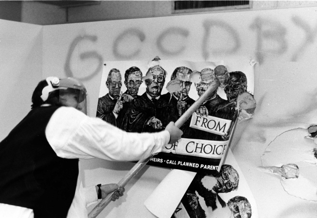 An anti-abortion activist smashes a pro-choice poster at a rally on the University of Wisconsin-Madison campus. 