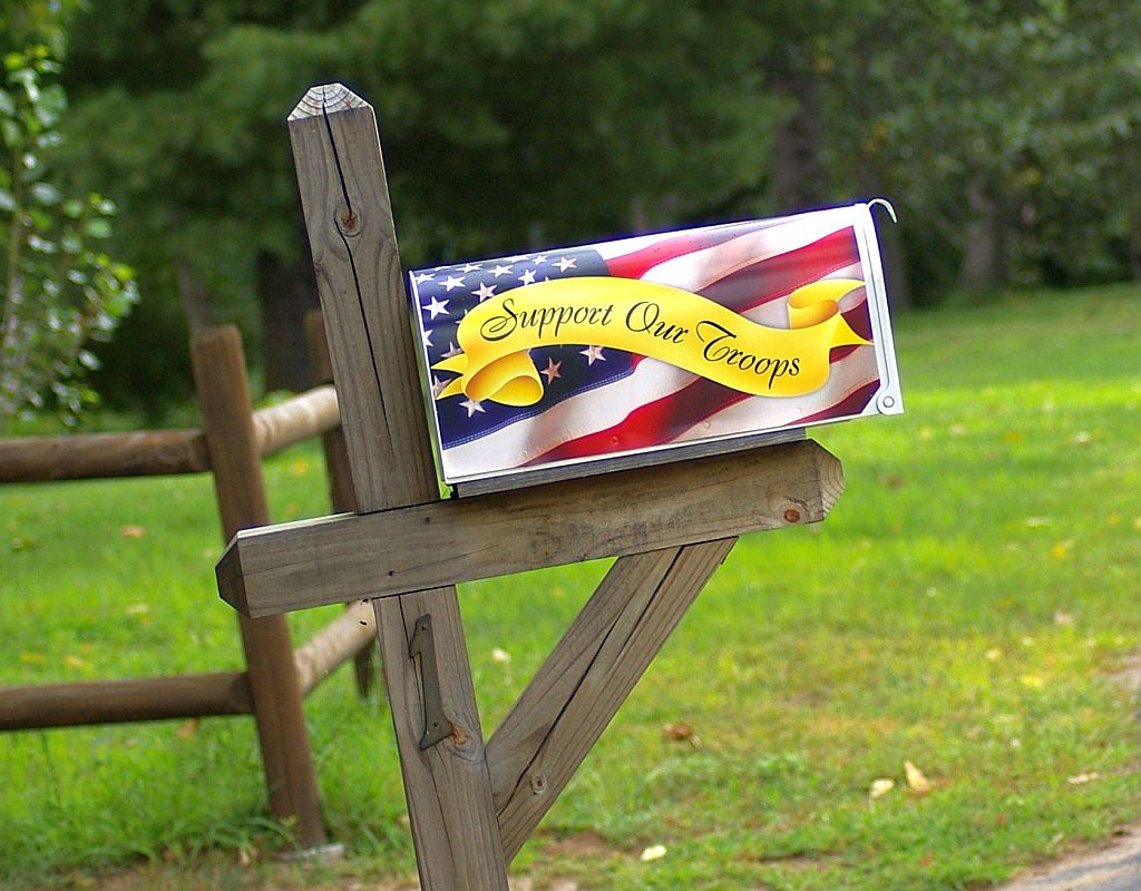 A mailbox painted with a U.S. flag and yellow ribbon that says "Support Our Troops"
