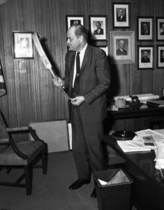 TDC director Geroge Beto posing with the "bat,“ Texas's principal instrument of convict discipline from antebellum times through World War II. Photo 1965. Courtesy of TDCJ.